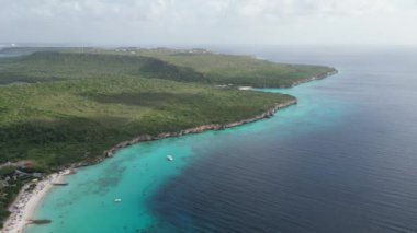 Aerial drone footage over Grote Knip in West Punt Curaca. Carribean beach drop down footage over the clear sea and sand. High quality 4k footage