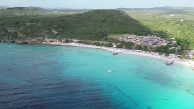 Aerial drone footage over Grote Knip in West Punt Curaca. Carribean beach drop down footage over the clear sea and sand. High quality 4k footage