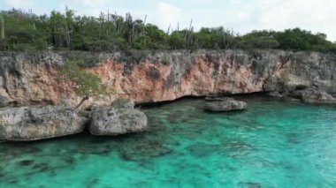 Aerial drone footage over Grote Knip in West Punt Curaca. Carribean beach drop down footage over the clear sea and sand. High quality 4k footage