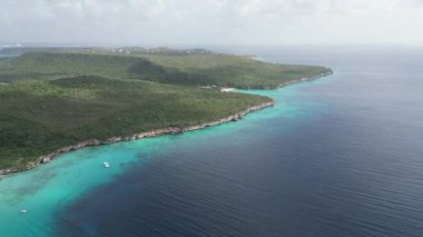 Aerial drone footage over Grote Knip in West Punt Curaca. Carribean beach drop down footage over the clear sea and sand. High quality 4k footage