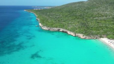 Aerial drone footage over Grote Knip in West Punt Curaca. Carribean beach drop down footage over the clear sea and sand. High quality 4k footage
