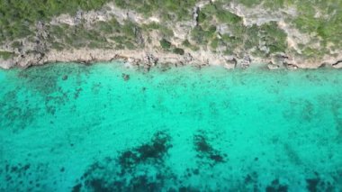 Aerial drone footage over Grote Knip in West Punt Curaca. Carribean beach drop down footage over the clear sea and sand. High quality 4k footage