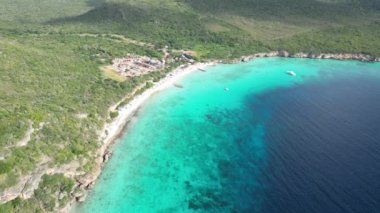 Aerial drone footage over Grote Knip in West Punt Curaca. Carribean beach drop down footage over the clear sea and sand. High quality 4k footage