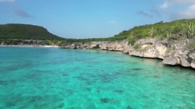 Aerial drone footage over Grote Knip in West Punt Curaca. Carribean beach drop down footage over the clear sea and sand. High quality 4k footage