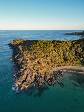 Aerial footage over Noosa Heads, Noosa National park Queensland Australia during a blue sky cloud free day overlooking the ocean. High Quality Video clipart