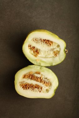 Küçük karpuz, çiftlik hasadı koyu bir arka planda ikiye bölünmüş.