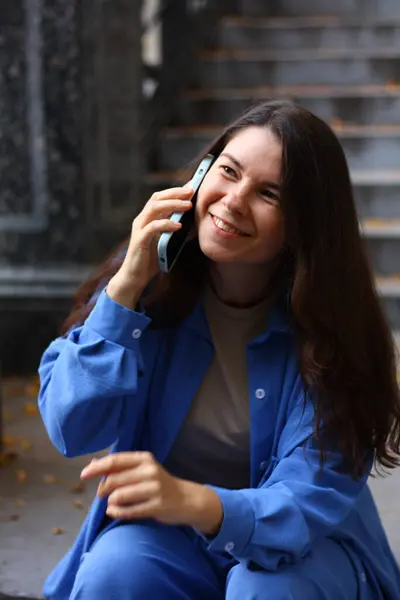 woman is talking on the phone and laughing