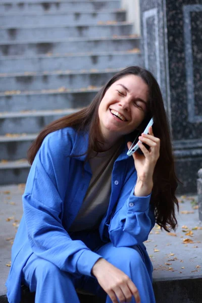 woman is talking on the phone and laughing