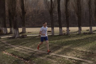 Şehrin dışında koşan profesyonel bir koşucu var.