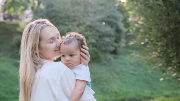 Caucasian Mother Gently Hugs Her African Child Holds Him Her — Stock Video