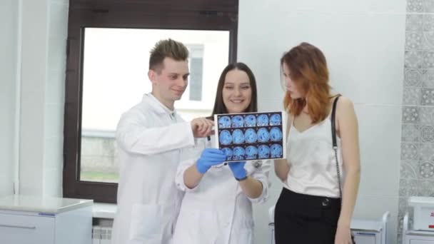 Young Doctors Show Patient Brain Scan Tomography Medical Consultation — Video Stock