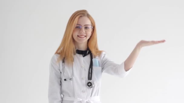Red Haired Girl Doctor White Coat Shows Empty Palm White — Wideo stockowe