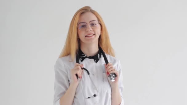 Young Doctor Girl Red Hair Poses Holding Stethoscope Her Neck — Vídeos de Stock