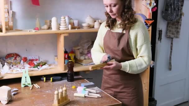 Girl Master Makes Handmade Wooden Toys Workshop Impregnates Wood Oil — Stock Video