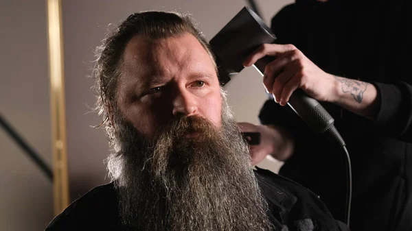 Young Stylist Does Styling Hair Dryer Bearded Man Sitting Barber — Stock Photo, Image