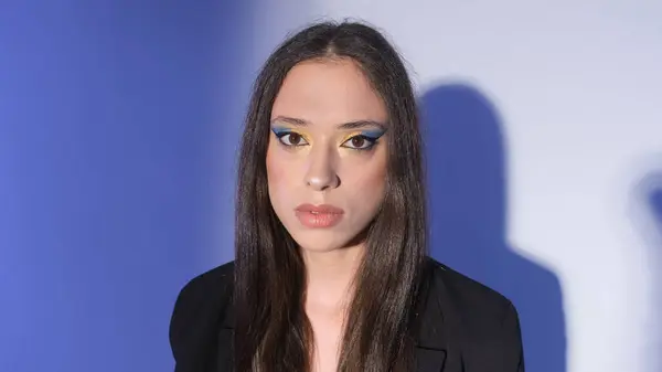 Stylish Brunette Girl Bright Makeup Black Suit Blue Background — Stock Photo, Image