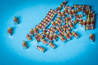 SMD diodes, on a table with a blue background, electronic components
