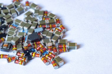 Çeşitli elektronik bileşenler, direnişçiler, kapasitörler, diyotlar, transistörler.
