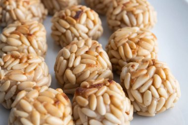 Ev yapımı panellerin yakın çekimi, geleneksel çam fıstığı kaplı Katalan badem ezmesi tatlısı, genellikle Azizler Günü 'nde yenir..