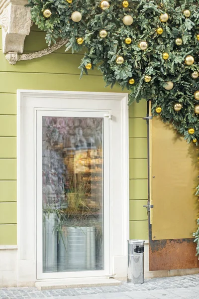 stock image Window of shop or cafe, decorated with Christmas tree and golden balls.