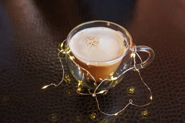 cup of coffee with cinnamon sticks on a wooden background clipart