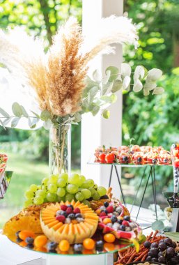 wedding cake with grapes on a table