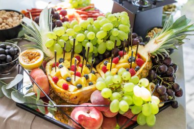 table full of fruit appetizers, fresh salad