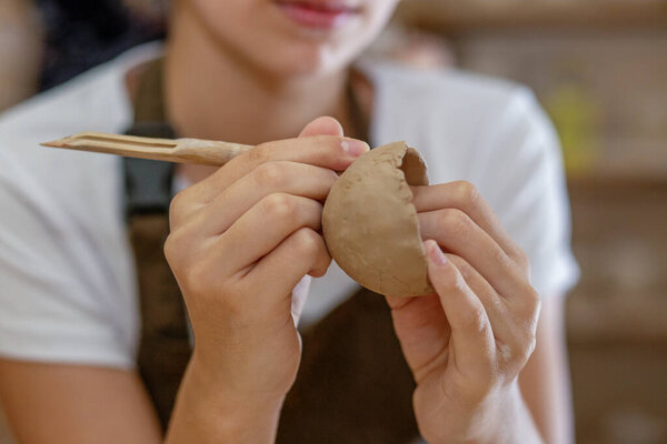 Craft and clay art. Children's creative. Arts education. Close up of hands making bowls in a pottery workshop