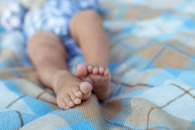 closeup view of baby feet lying on bed, close-up