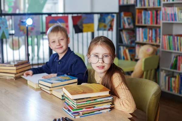 Little School Children Reading Books Together While Sitting Table Library — Stockfoto