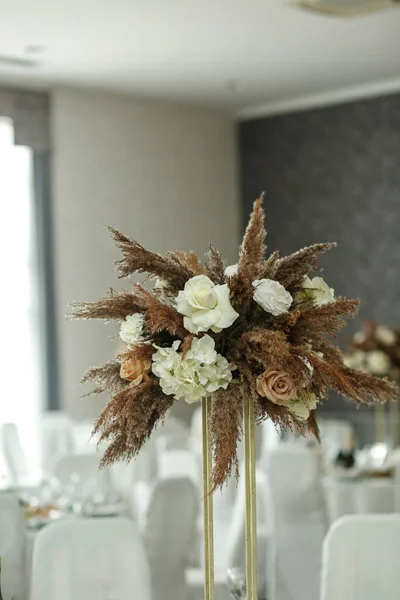 Wedding decorations. Wedding event. Decor of the wedding table with fresh flowers and pampas grass.