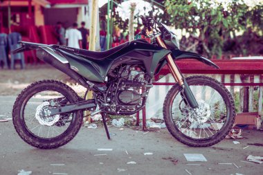 Bir Honda CRF 150L motosiklet, bir çeşit toprak motosiklet, yol kenarına park edilmişti..