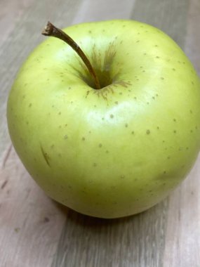 Ahşap bir tahtanın üzerinde yeşil bir elma uzanıyor mutfak, vitaminler, yararlı, sağlık, yemek, sebze, meyve, lezzetli, iştah açıcı, hayatı seviyorum, yemek pişirmeyi seviyorum..