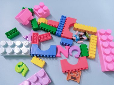 Çocuk oyuncakları geçmişi. Gökyüzü mavi arka planında renkli bloklar ve alfabe oyuncakları.