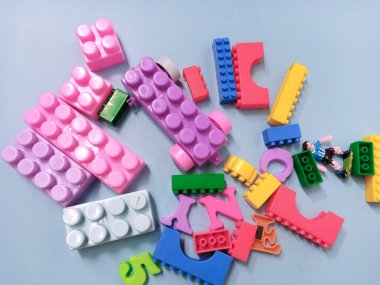 Çocuk oyuncakları geçmişi. Gökyüzü mavi arka planında renkli bloklar ve alfabe oyuncakları.