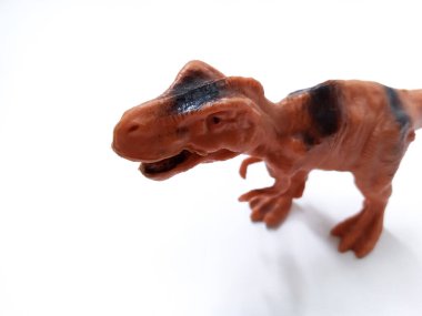 Tyrannosaurus Rex dinozor Oyuncak Figürü. Beyaz arka planda izole edilmiş plastik dinozor oyuncağı. Tyrannosaurus, büyük bir theropod dinozor cinsidir.