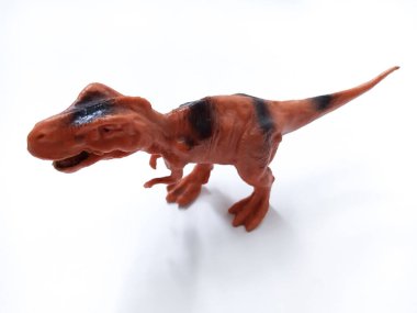 Tyrannosaurus Rex dinozor Oyuncak Figürü. Beyaz arka planda izole edilmiş plastik dinozor oyuncağı. Tyrannosaurus, büyük bir theropod dinozor cinsidir.