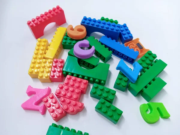 Close Up Colorful Educational Toys Bricks Blocks isolated on White Background. Multicolored plastic building blocks of the designer
