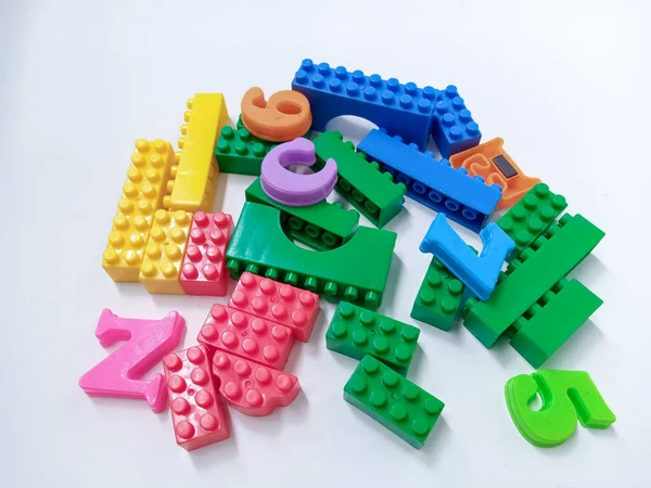 Close Up Colorful Educational Toys Bricks Blocks isolated on White Background. Multicolored plastic building blocks of the designer