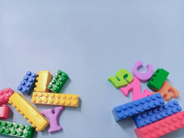 Kid Toys background. Colorful blocks and alphabet toys on sky blue background.
