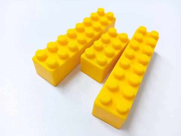 Close Up Yellow Educational Toys Bricks Blocks isolated on White Background