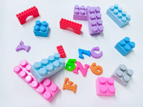 Kid Toys background. Colorful blocks, alphabet toys and Dinosaurs toys frame on white background.