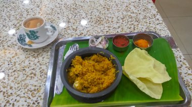 MALAYSIA, KL 2018 15 Ekim, Nasi kandarına yakın çekim eşsiz bir kap ve bir fincan sütlü kahve.