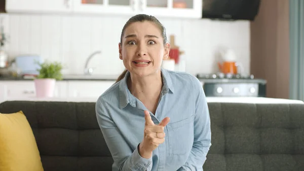 stock image Young woman arguing and shouting angrily reacts to her lover or husband. Hysterical angry young woman crying crying looking at camera. She is crazy, angry and yelling and fighting at the other person.