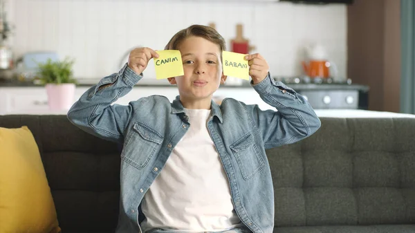 Mother's day, father's day, romantic concept.Message video of a happy kid holding paper notes with 