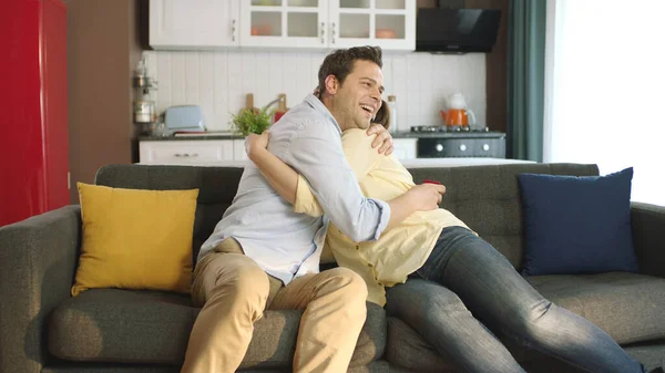 stock image A young man gives his girlfriend a nice gift for Valentine's Day. Young couple happily hugging each other. Marriage proposal.