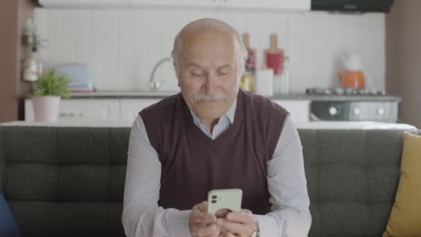 Old Man Spends Time His Smartphone While Drinking Coffee Home — Stock Video