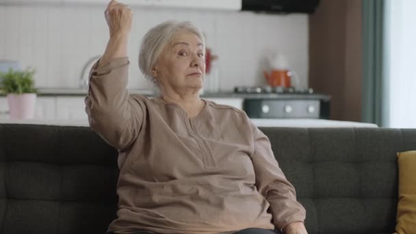Μια Ηλικιωμένη Γυναίκα Σηκώνει Χέρια Της Και Δείχνει Δικέφαλους Στην — Αρχείο Βίντεο