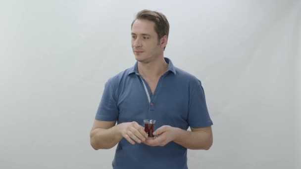 Young Man Drinking Turkish Black Tea Transparent Glass Indoor Studio — Stock Video