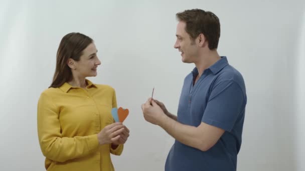 Young Couple Dancing Celebrating Paper Hearts White Background Lovers Who — Stock Video